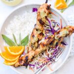 bowl of honey orange dijon chicken skewers with slaw