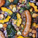 top down view of a sheet pan dinner with roasted acorn squash and sausager