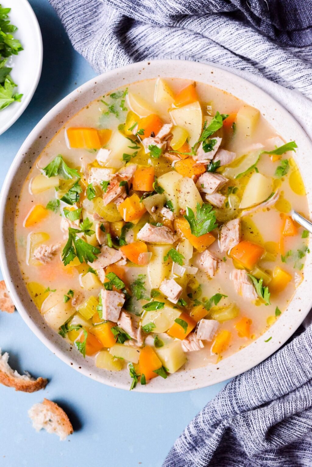 top down view of crockpot turkey soup in a white bowl