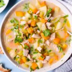 top down view of crockpot turkey soup in a white bowl
