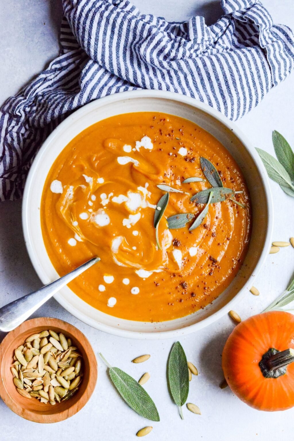 Overhead shot of a white bowl with pumpkin and sweet potato soup