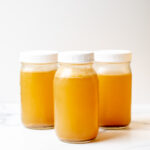 3 glass mason jars filled with stock.