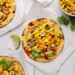 Overhead shot of tacos on parchement paper squares.