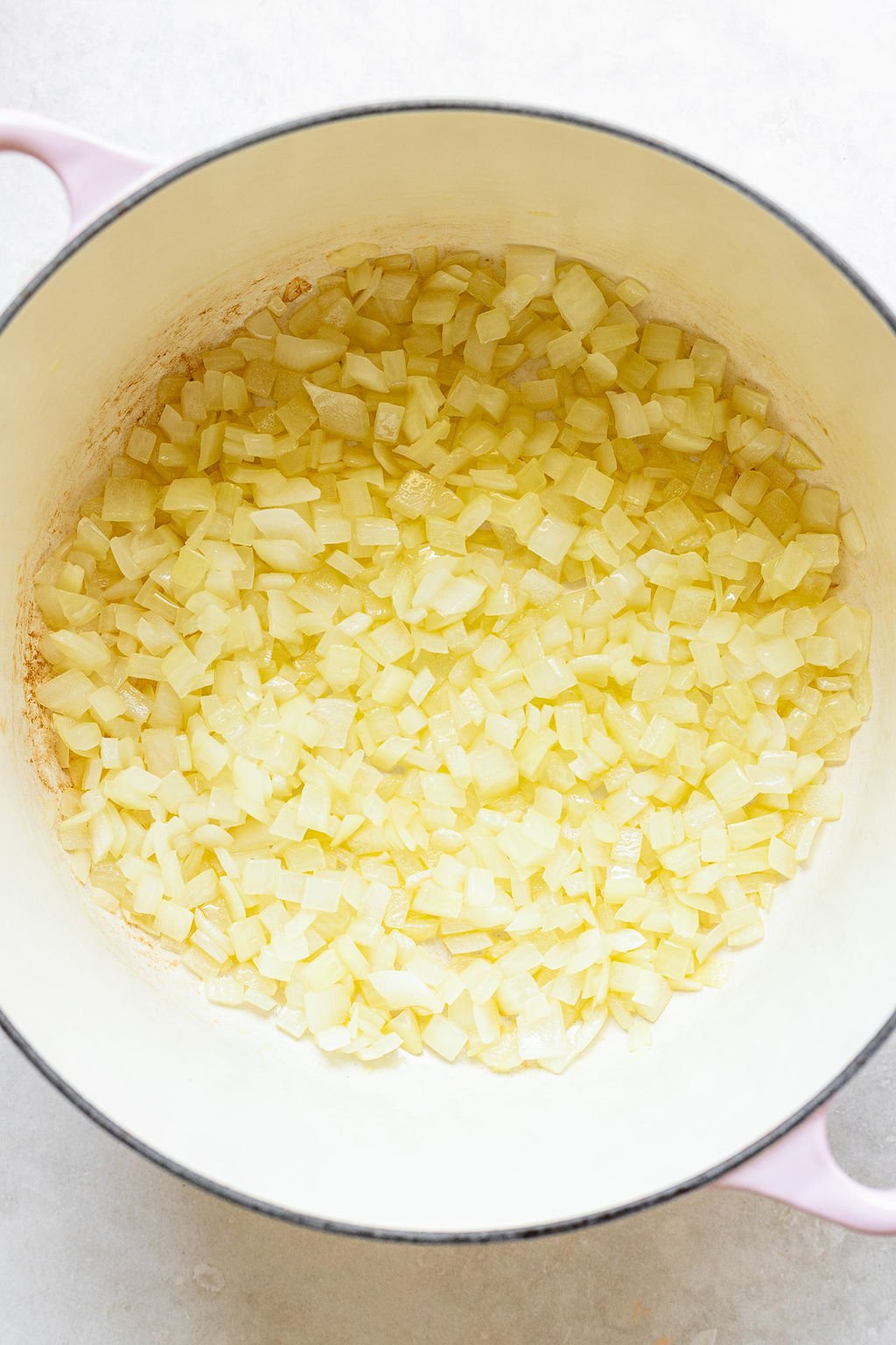 Overhead shot of a pot with cooked diced onions.