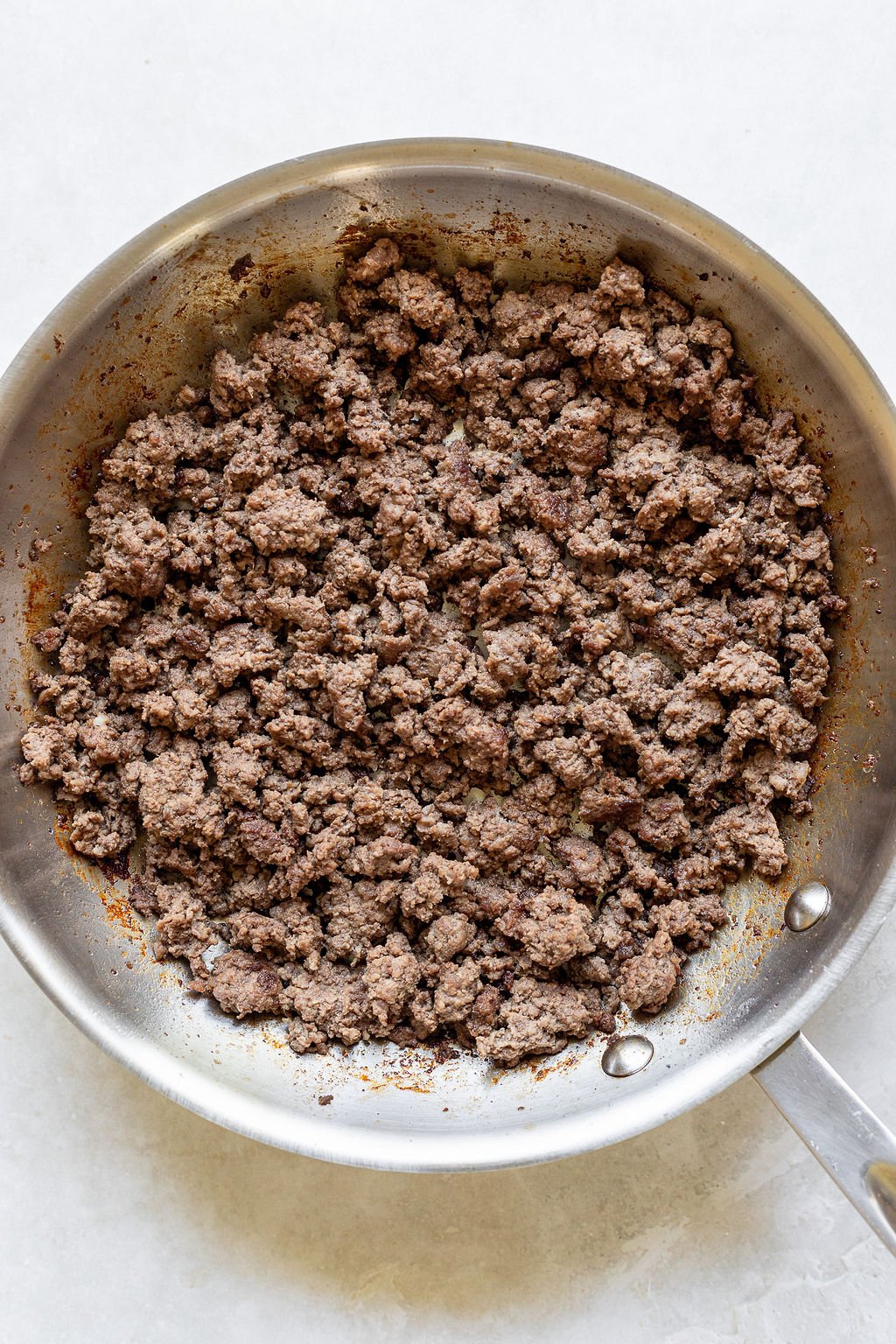 Overhead shot of a skillet with browned ground beef.