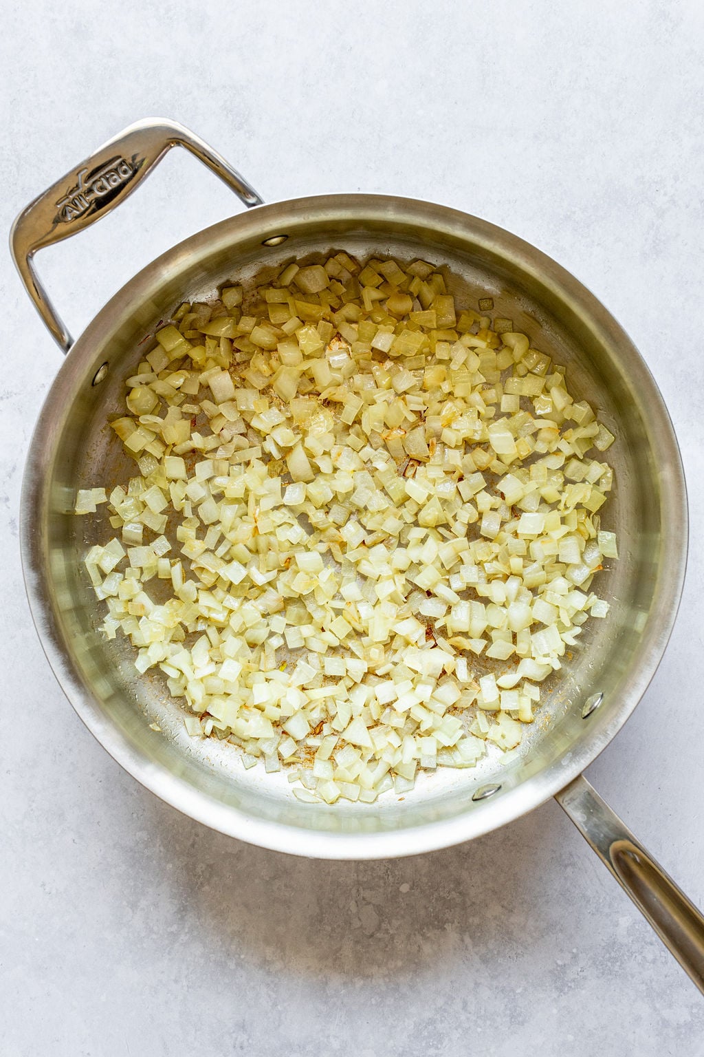 Saucepan with cooked, diced onion.