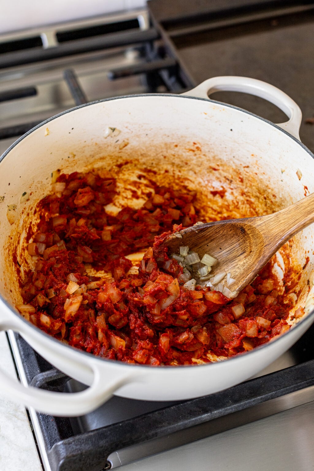 Diced onions and tomato paste cooked in a large pot.