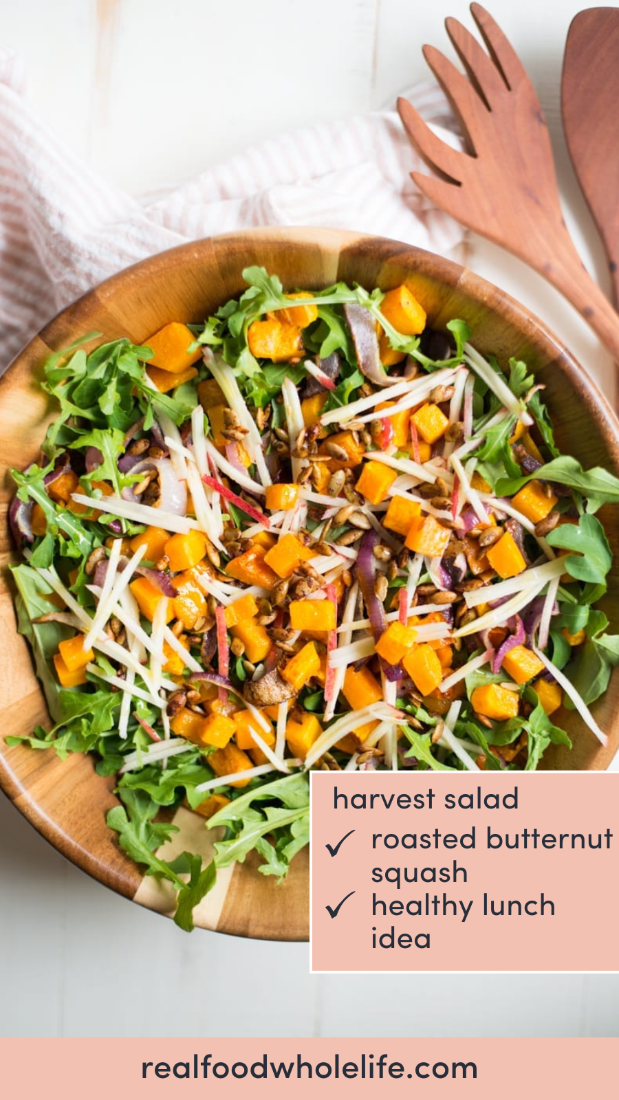 overhead shot of a salad bowl with arugula with roasted butternut squash with the text "harvest salad"