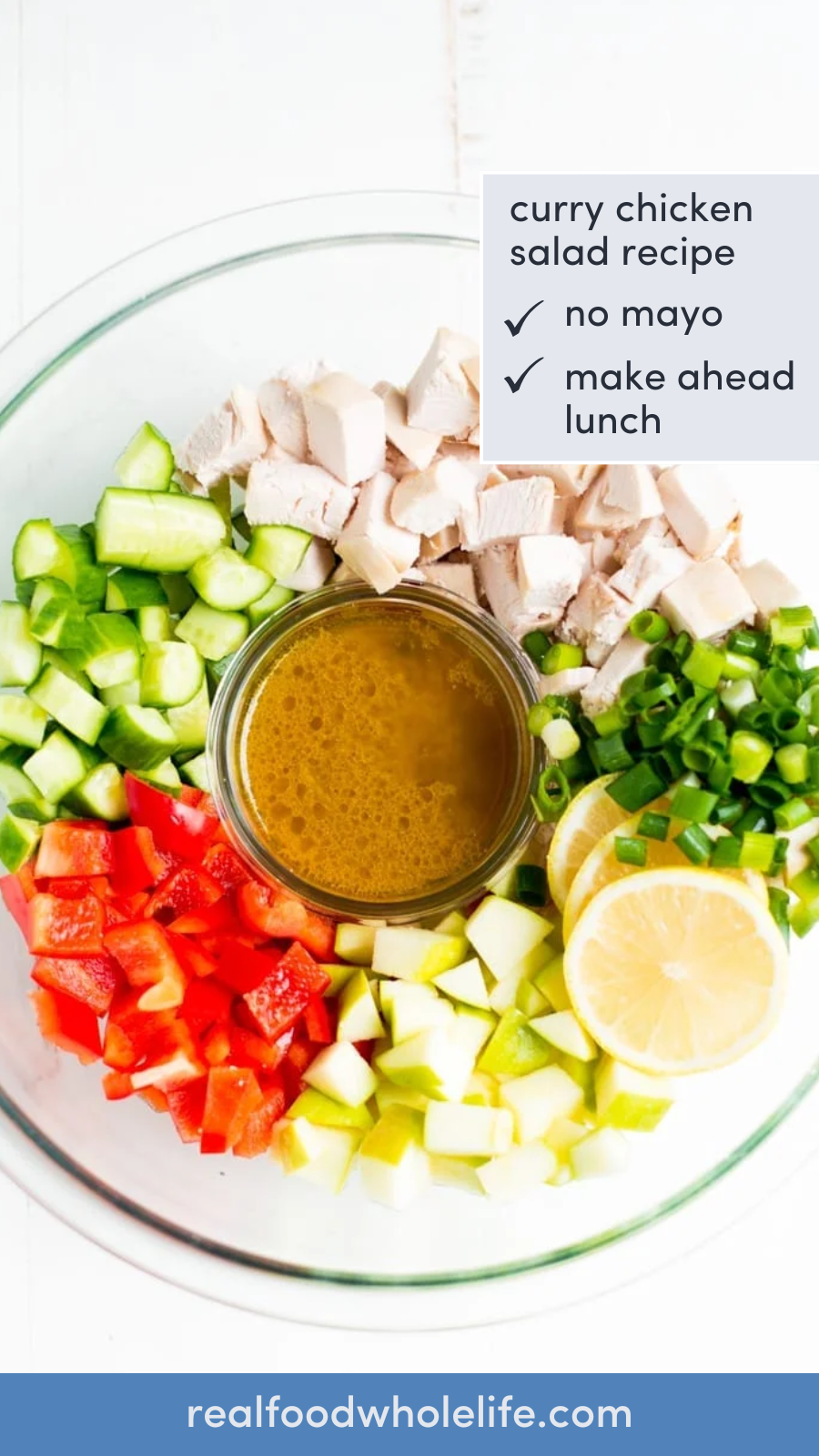 Overhead shot of a glass bowl with chopped chicken, cucumber, red peppers, apple, and green onions with the text "curry chicken salad recipe."