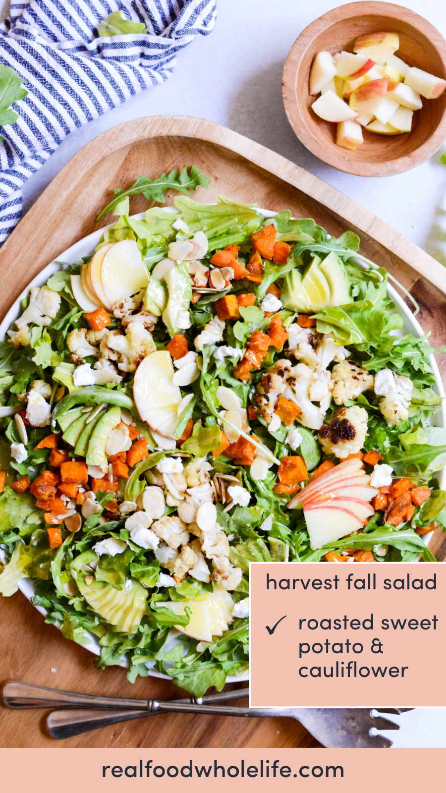 Overhead shot of a bowl with arugula, sliced apple, chicken, roasted cauliflower, and cubed sweet potato with the text "harvest fall salad."
