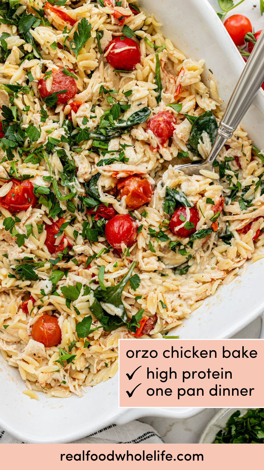 Overhead shot of a baked orzo dish with cherry tomatoes and topped with parsley.