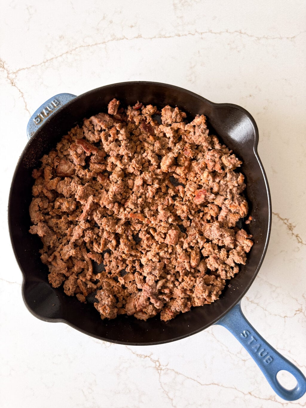 Cooked ground beef in a large skilllet.