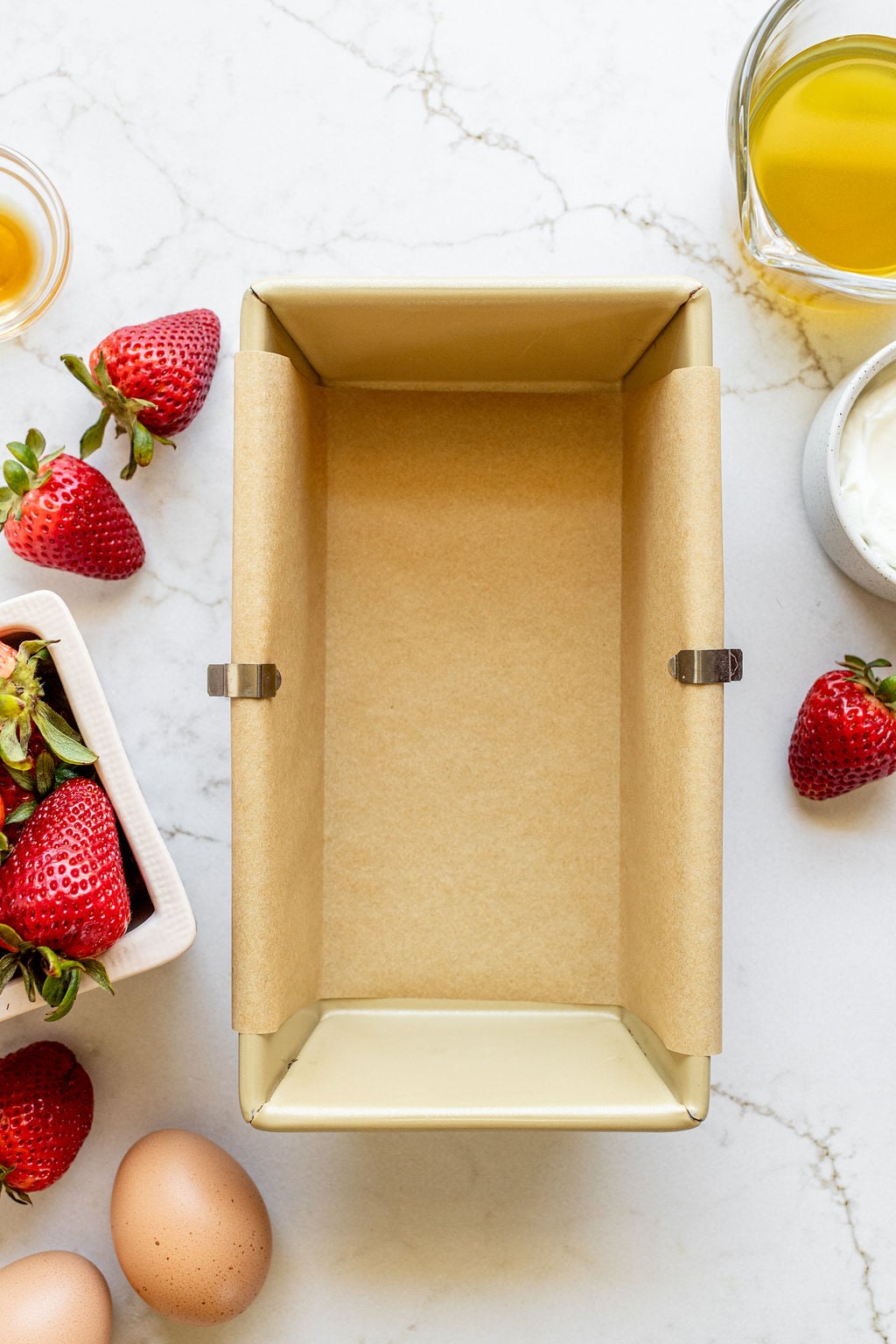 A loaf pan lined with parchment paper.