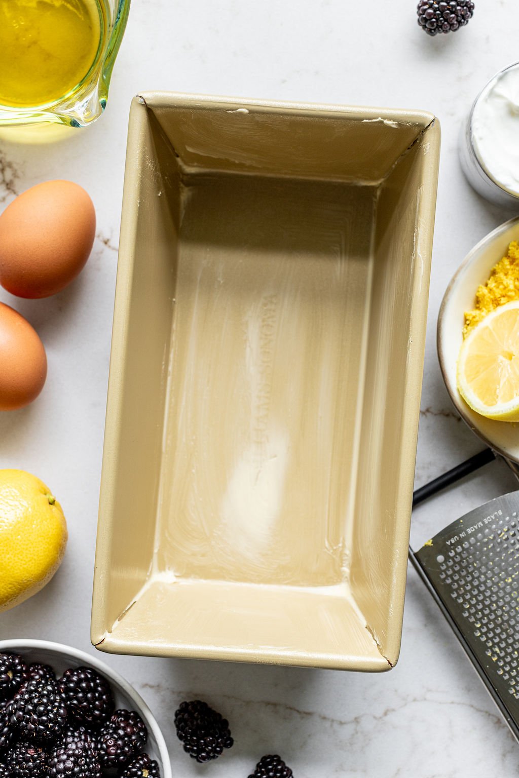 A loaf pan lined with parchment paper and greased.