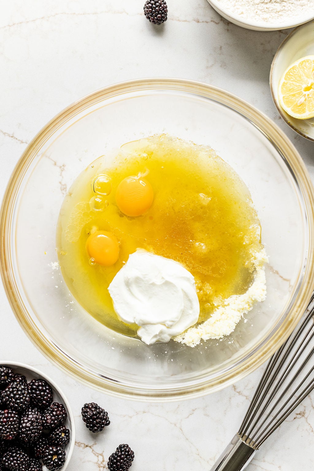 Eggs, oil, and yogurt in a large mixing bowl.