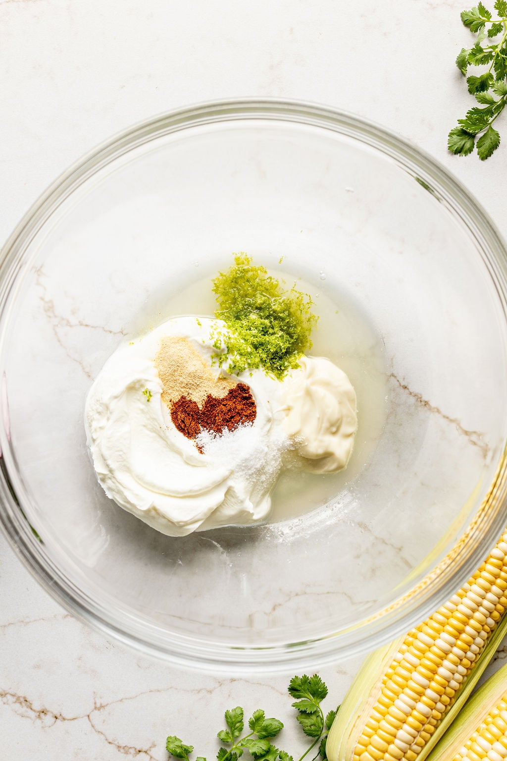Mayonnaise, Greek yogurt, lime zest, spices, and lime juice in a mixing bowl.