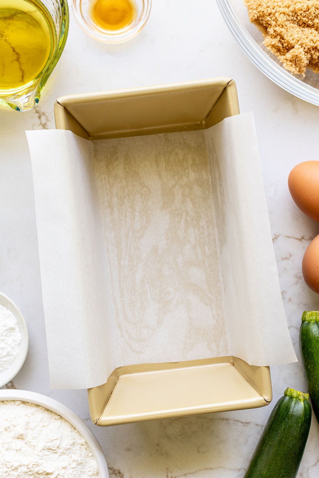 A loaf pan lined with parchment paper.