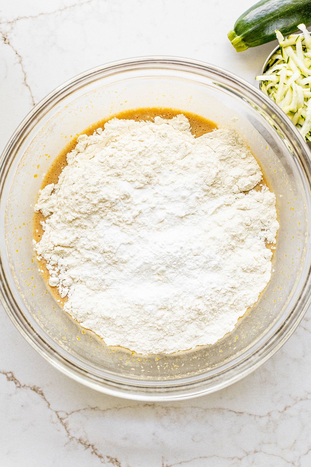 Flour sprinkled in a mixing bowl.