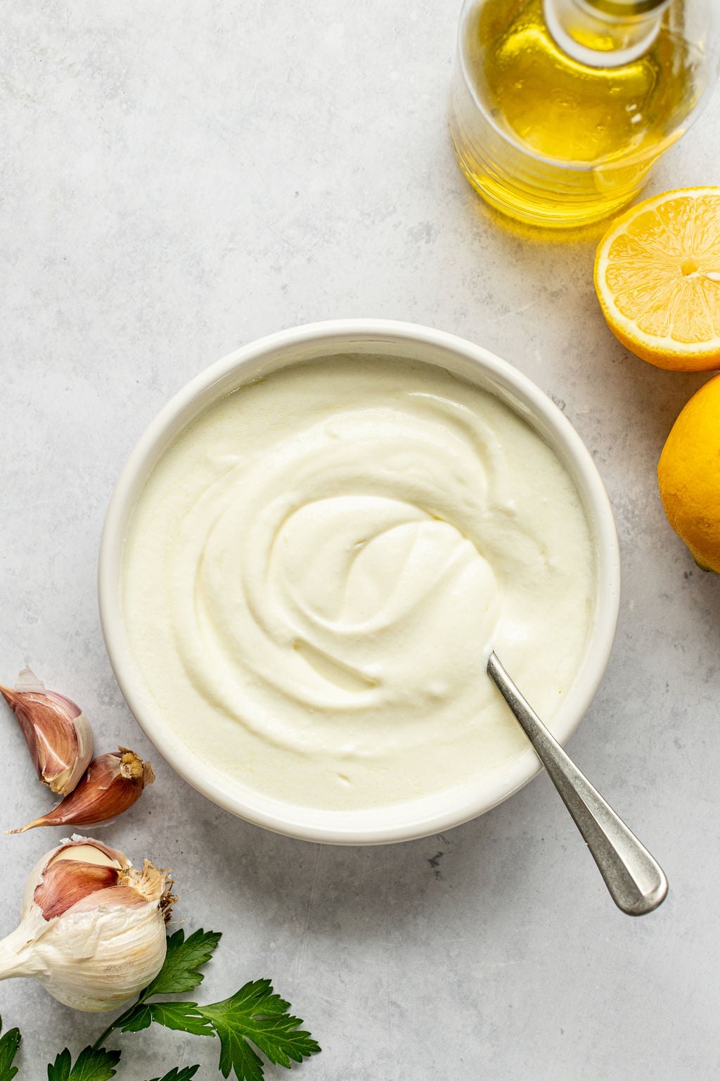 A creamy, thick, white mixture in a bowl with a spoon.