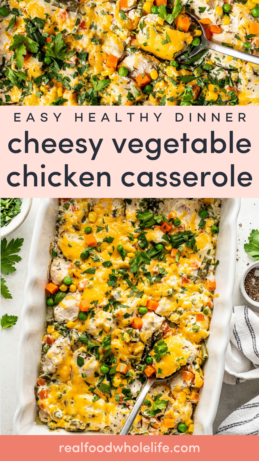 A baked cheesy vegetable chicken casserole in a white dish, topped with melted cheese, carrots, peas, and herbs, with a serving spoon and fresh parsley on the side.