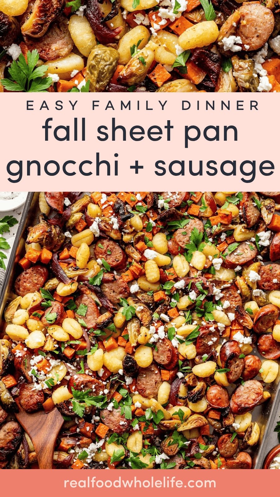 Sheet pan with roasted gnocchi, sausage, Brussels sprouts, carrots, and herbs, topped with crumbled cheese, shown with a wooden spoon.