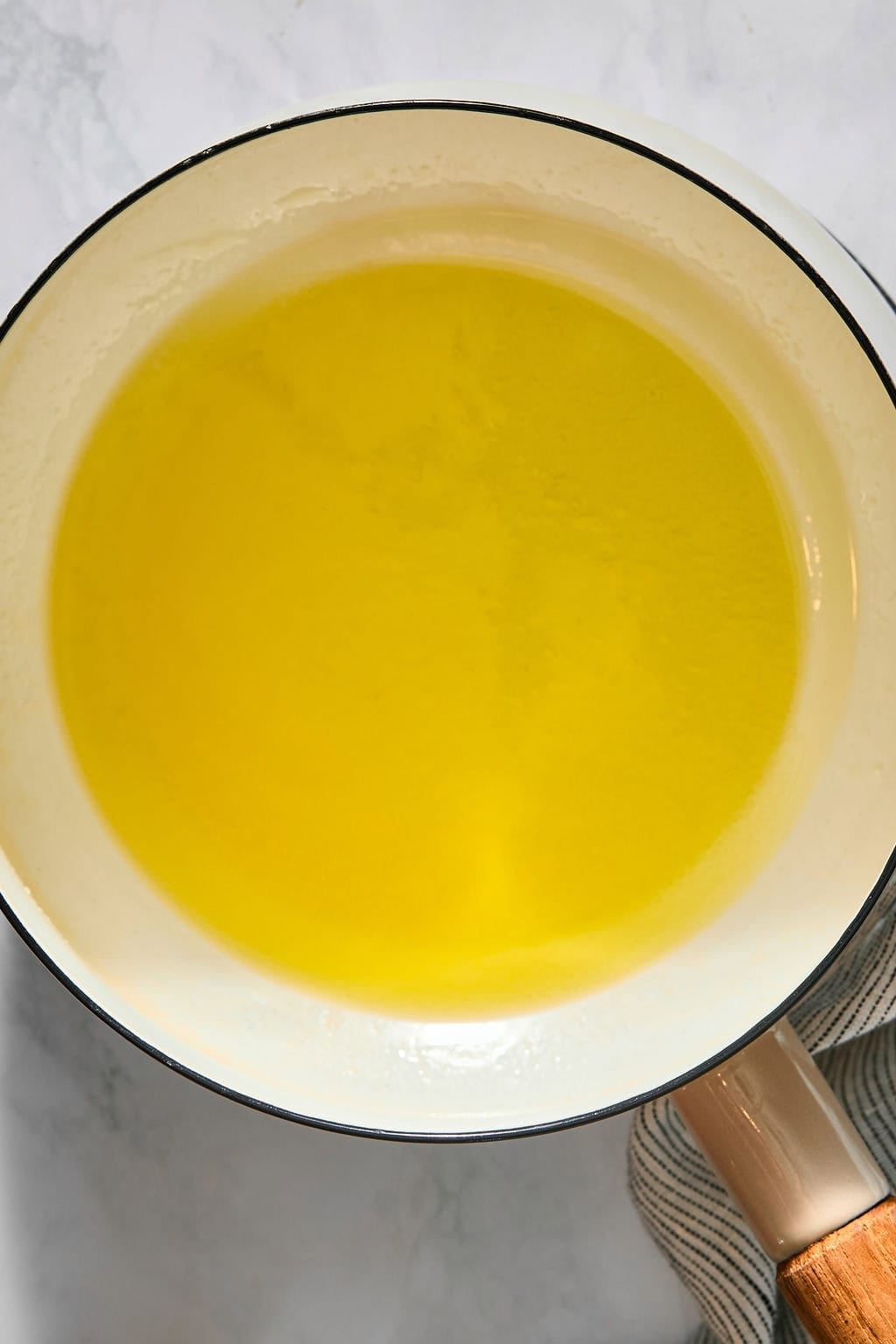 Melted butter in a white saucepan.